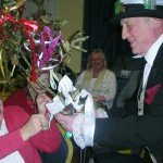 The President Linda Gould presented with rustic bouquet by the mummer Doctor as Lady of the House